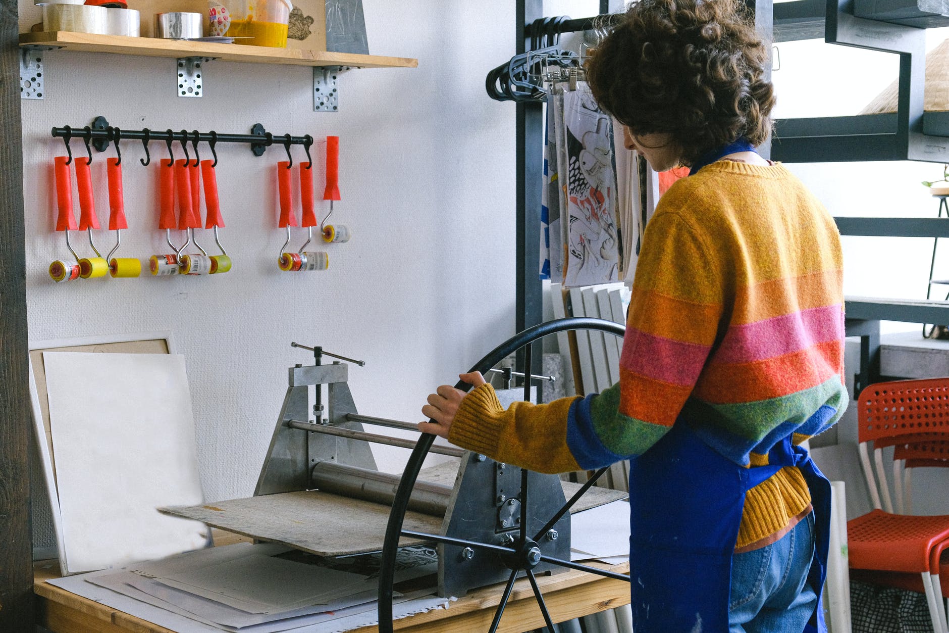 unrecognizable skilled woman at etching press