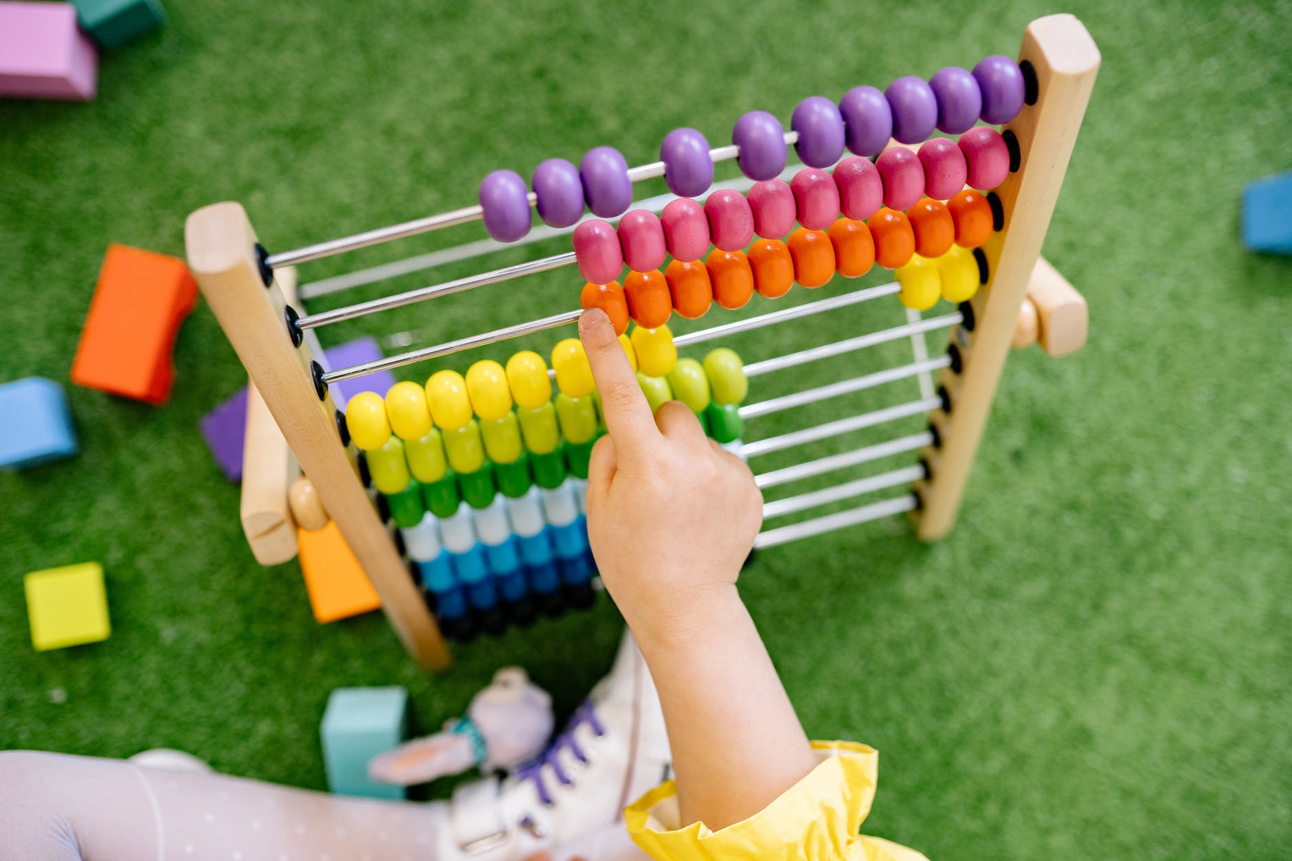 child playing with an abacus and learning to count